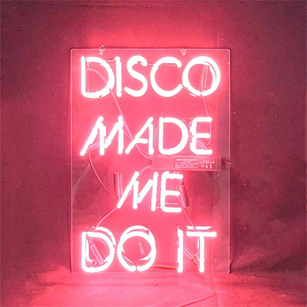 Disco Made Me Do It neon light sign glowing pink with acrylic backing suspended by metal chain