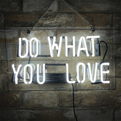 Do What You Love Neon Sign with glowing pink script on a light background