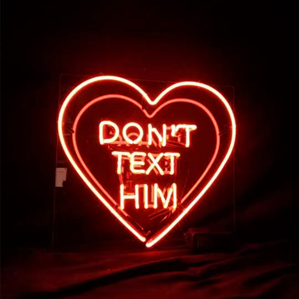 Don't Text Him with Heart Neon Sign lit in warm pink glow mounted on acrylic backing