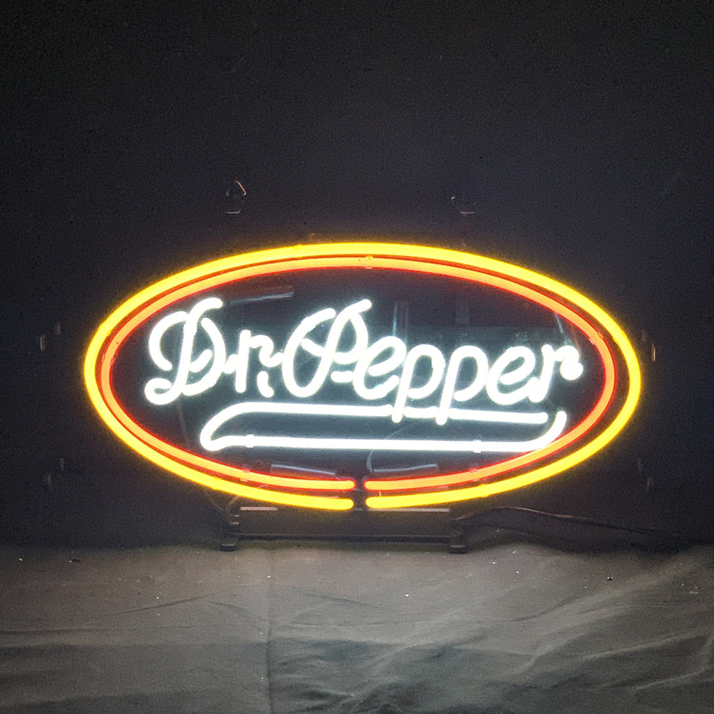 Dr Pepper Neon Signs illuminated against a dark background highlighting red and white neon tubes.