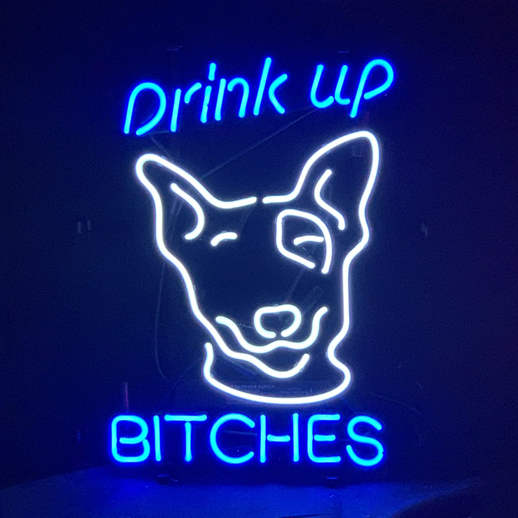 Drink Up Bitches Neon Sign Light glowing against a neutral wall