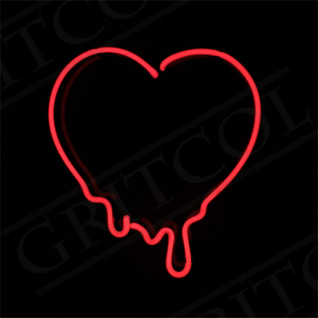 Red neon light shaped like a heart with drips extending downward against a black background.
