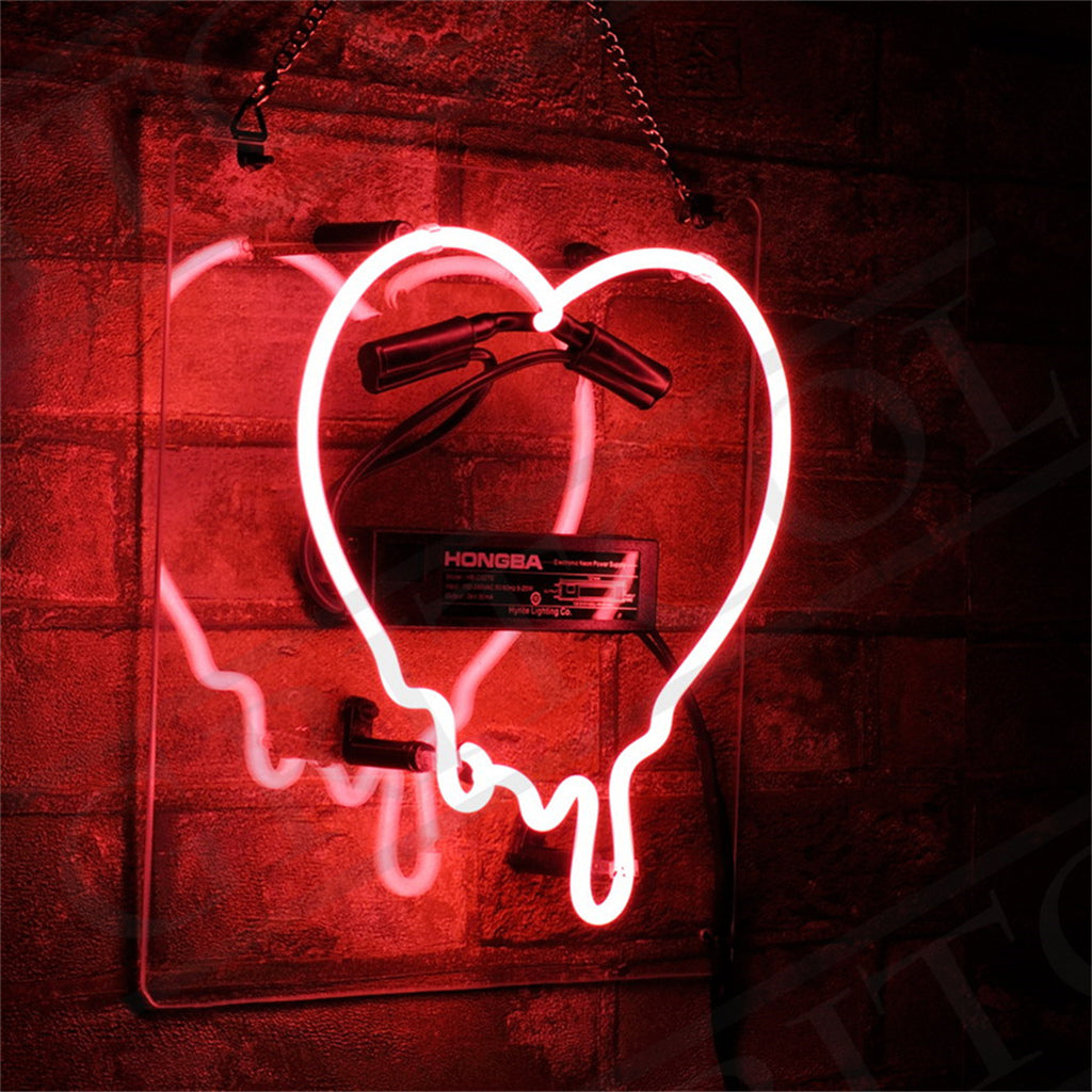 Red neon sign shaped like a dripping heart mounted on a brick wall, reflecting a glowing outline on a transparent backing with visible wiring and a black transformer box.
