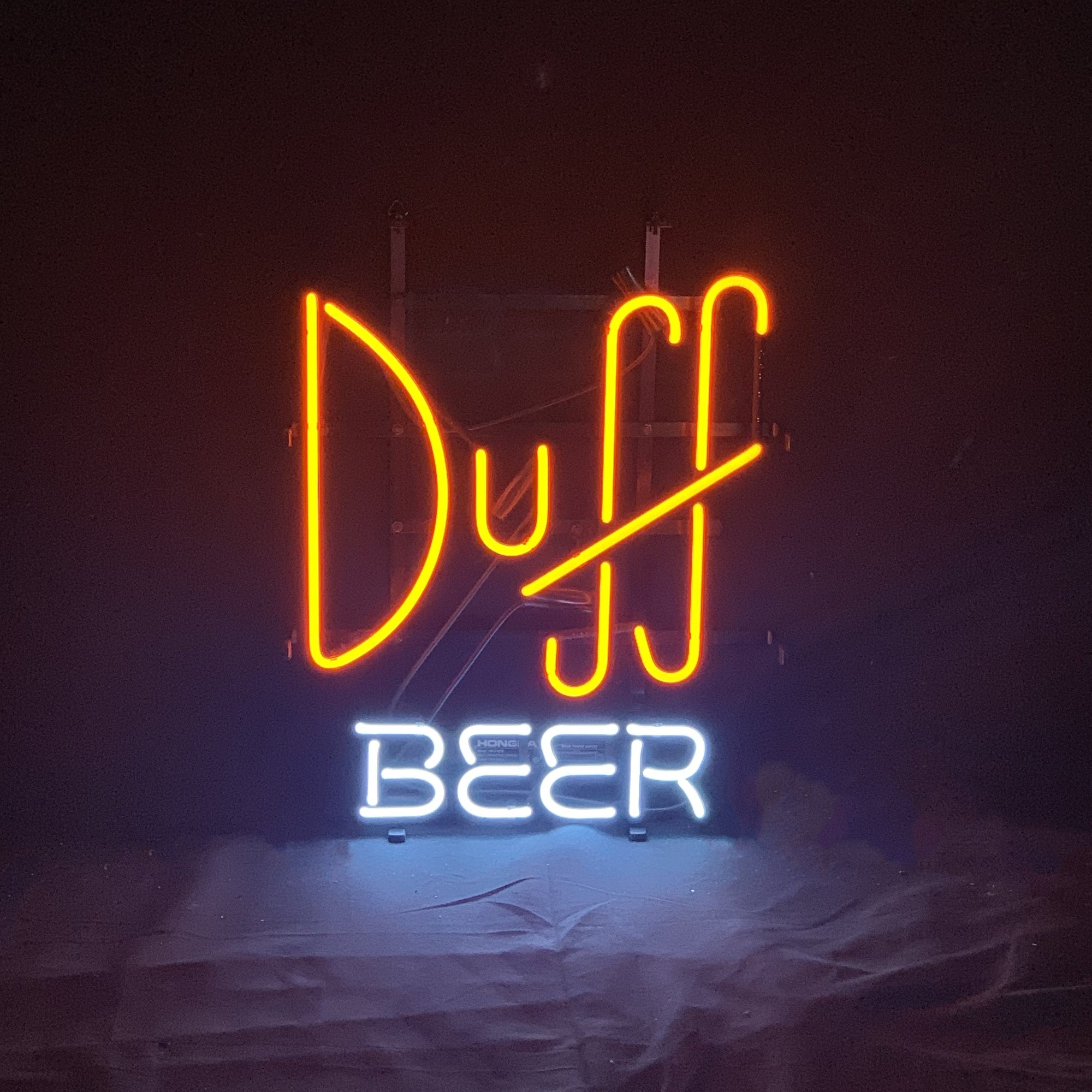 Duff Beer Neon Sign lit up against a dark background
