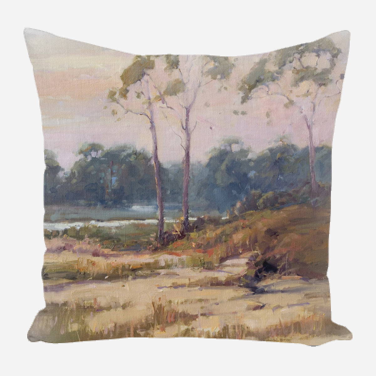Pillow printed with a calming landscape painting featuring slender trees on a sandy dune with soft pastel sky and muted greenery in the background.