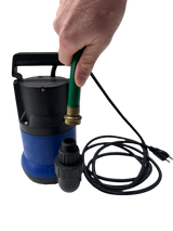 Black and blue submersible pump connected to a green hose held by a hand, with a coiled black power cord beside it on a white surface.