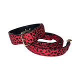 Red and black leopard print Italian leather dog collar and leash set laid out flat.