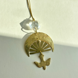 Chasing Light Ornament with hand-cut brass and vintage glass crystal hanging against white background