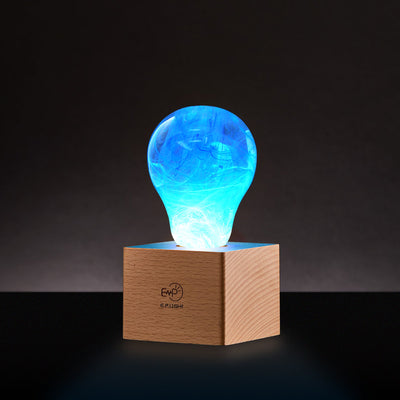 EP Light 4-Pack Resin LED Bulb Bundle showing four handcrafted resin LED bulbs and wooden base