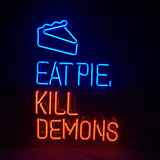 Neon sign with a blue outlined slice of pie above blue text reading 'EAT PIE,' and red text below reading 'KILL DEMONS' on a dark background.