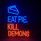 Neon sign with a bright blue outline of a pie slice above blue text reading EAT PIE and red text below reading KILL DEMONS on a dark background.