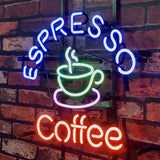 Curved blue neon text "ESPRESSO" above a green and white neon steaming coffee cup, with red neon "coffee" below, mounted on a brick wall.