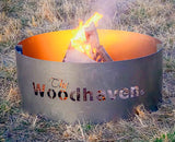 Woodhaven Portable Steel Fire Pit with stainless steel cooking grate, shown outdoors