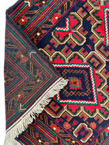 Hand-knotted Afghani Baluch wool rug with intricate geometric patterns in red, navy, green, and ivory, showing both front design and fringed reverse corner.