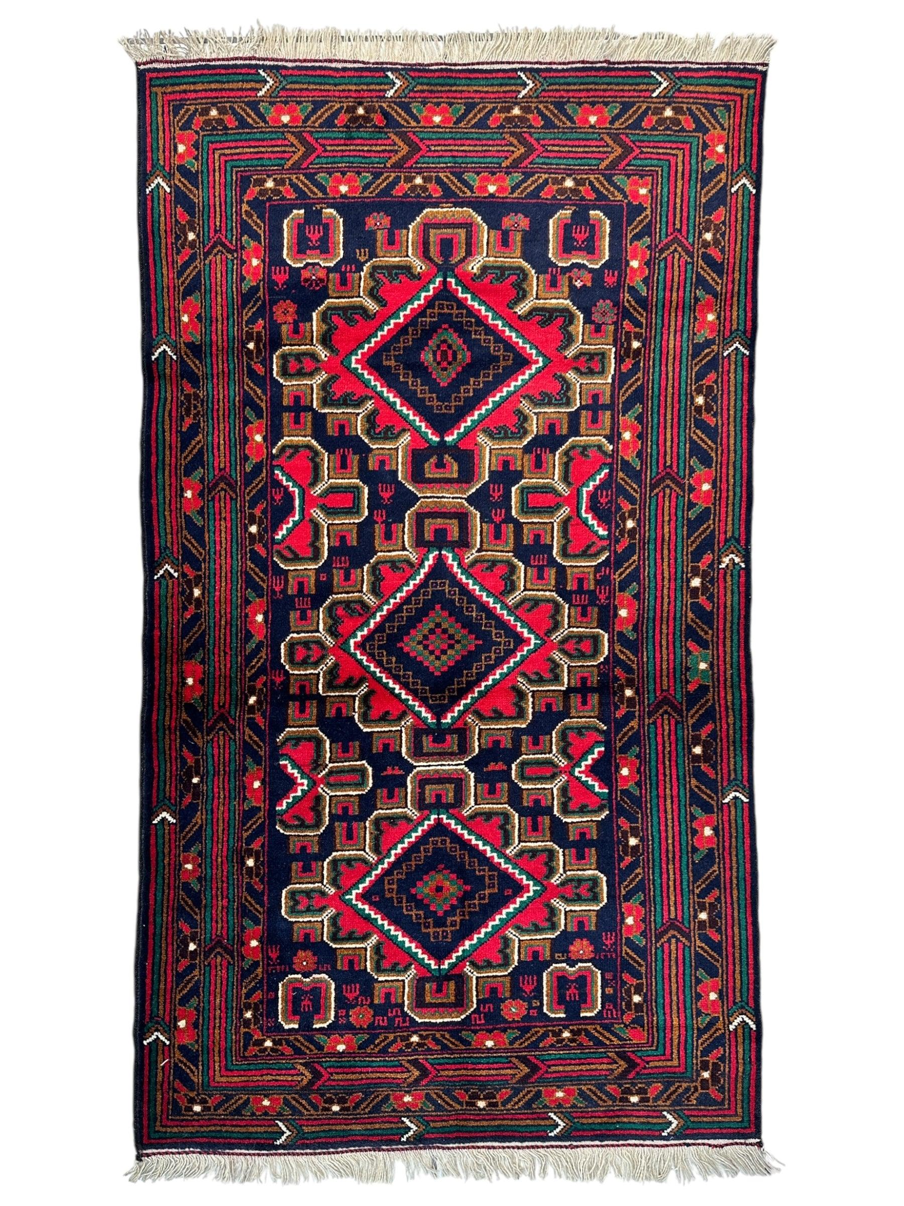 Hand-knotted Afghani Baluch wool rug with geometric patterns in earthy tones
