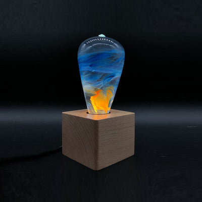 EP Light Fire Resin Table Lamp with wooden base and glowing LED bulb