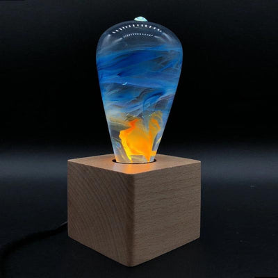 EP Light Fire Decorative Resin LED Bulb with glowing fire effect inside, shown with wooden base options