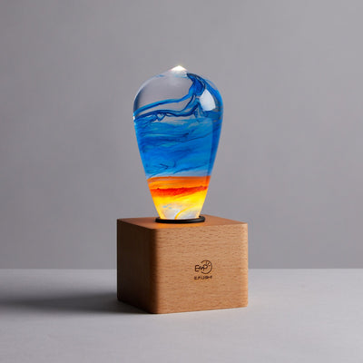 Three handcrafted resin LED light bulbs in a bundle, showing unique color patterns and resin designs