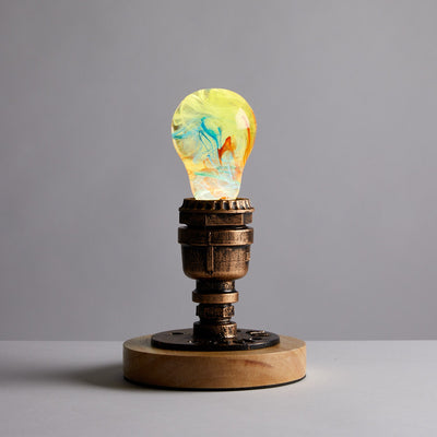 EP Light Firework Resin LED Bulb handcrafted with firework design in resin, shown with wooden base options
