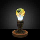 EP Light Firework Resin LED Bulb handcrafted with firework design in resin, shown with wooden base options