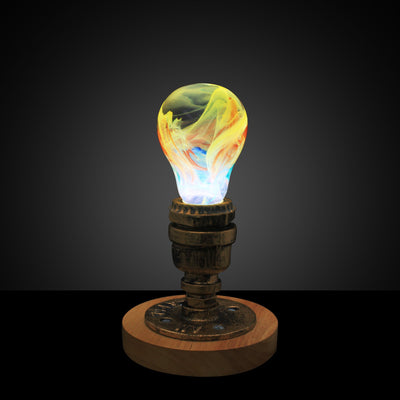 EP Light Firework Resin LED Bulb handcrafted with firework design in resin, shown with wooden base options