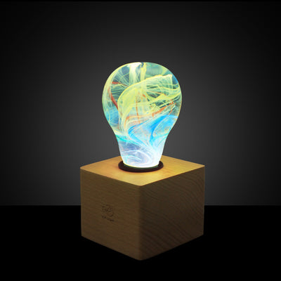 EP Light Firework Resin LED Bulb handcrafted with firework design in resin, shown with wooden base options