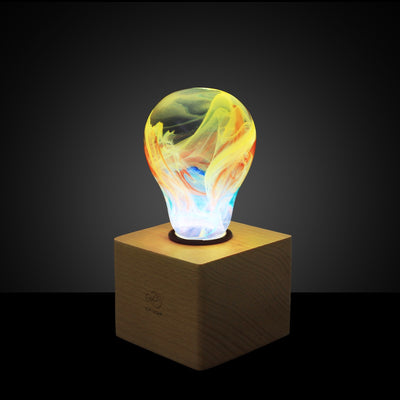 EP Light Firework Resin LED Bulb handcrafted with firework design in resin, shown with wooden base options