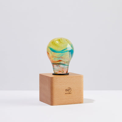 EP Light Firework Resin LED Bulb handcrafted with firework design in resin, shown with wooden base options