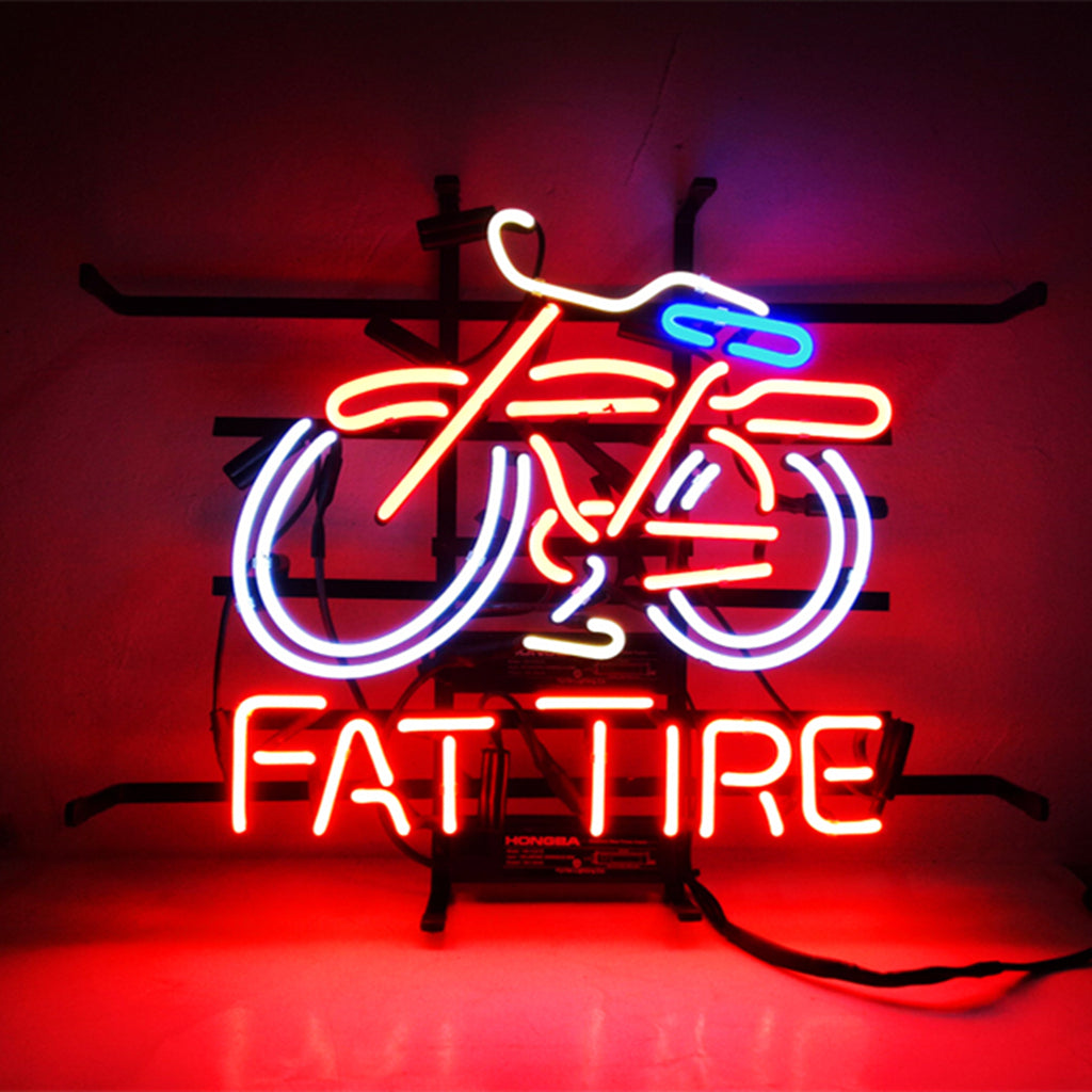Neon sign showing a bicycle outline with white and blue tubes, and red text below spelling 'FAT TIRE', all glowing against a dark background.