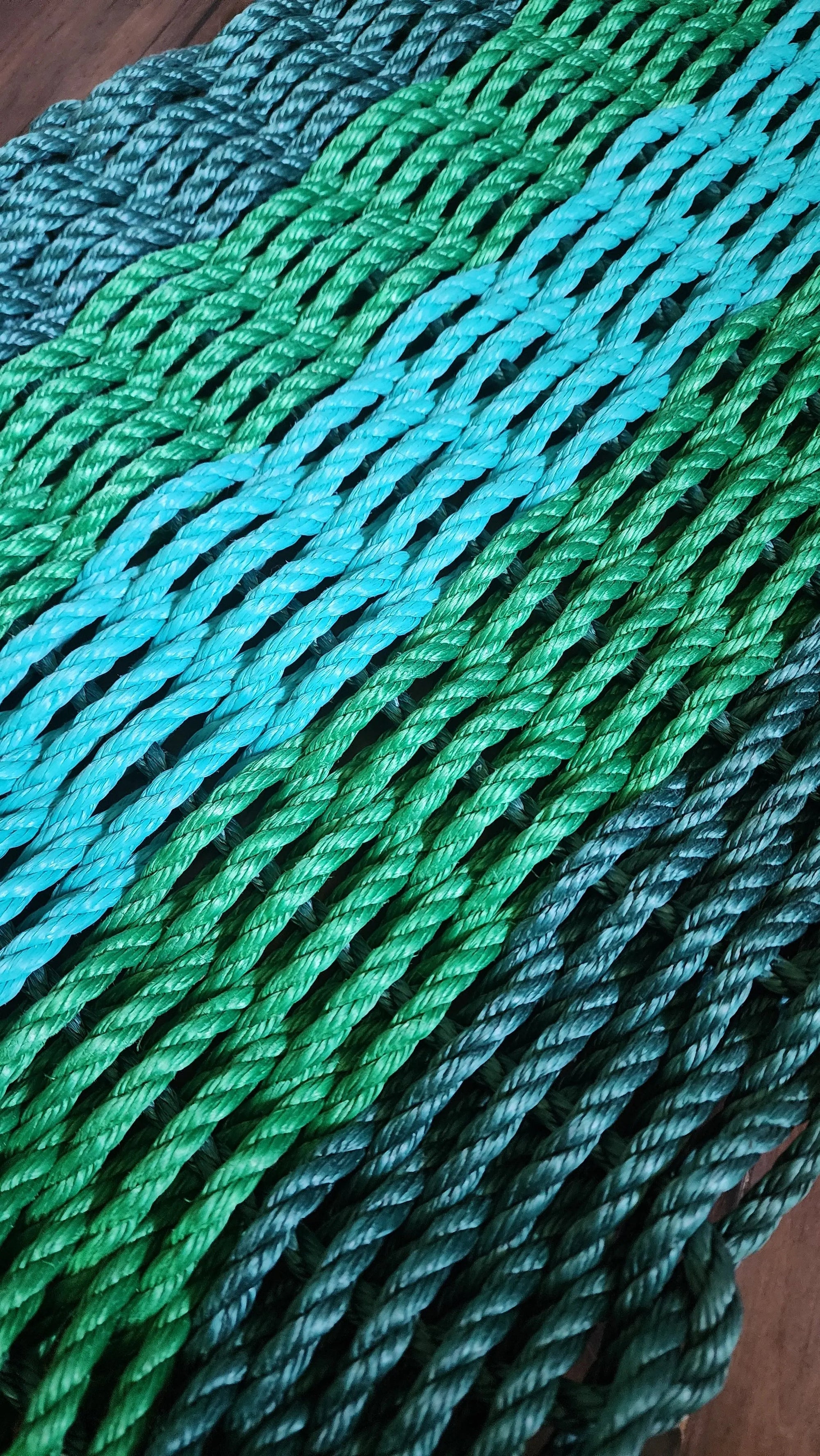 Five Stripe Rope Mat in hunter green, green, and teal colors