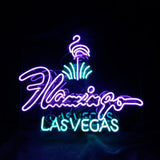 Neon sign featuring a purple flamingo above the word 'Flamingo' in purple script and 'LAS VEGAS' in blue block letters on black background.