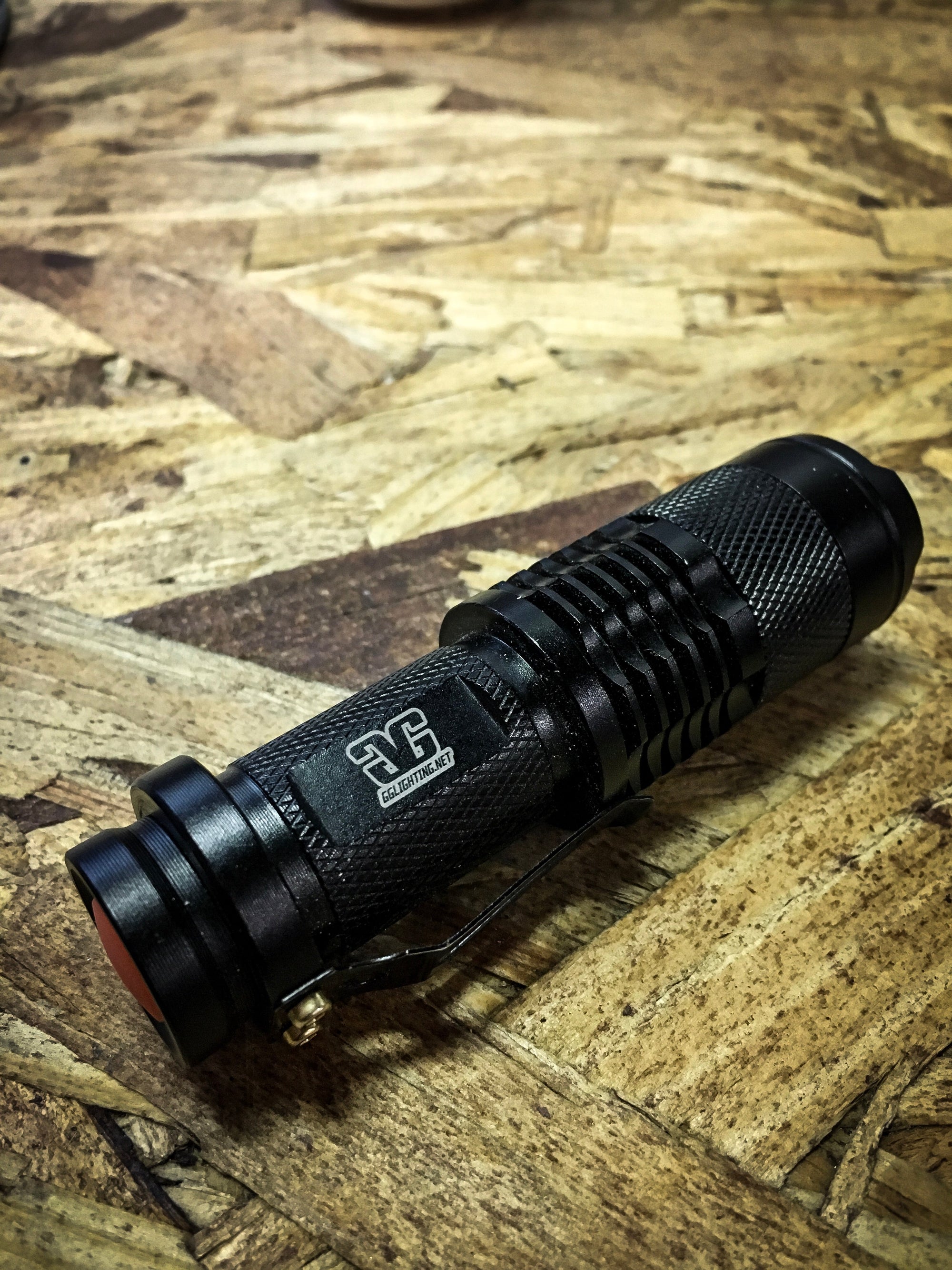 Three Function Rechargeable Flashlight by GGLighting showing black flashlight with wrist strap