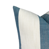 Close-up of a pillow cover with wide vertical stripes in white and lagoon blue textured fabric, showing detailed weave and sharp corner stitching.