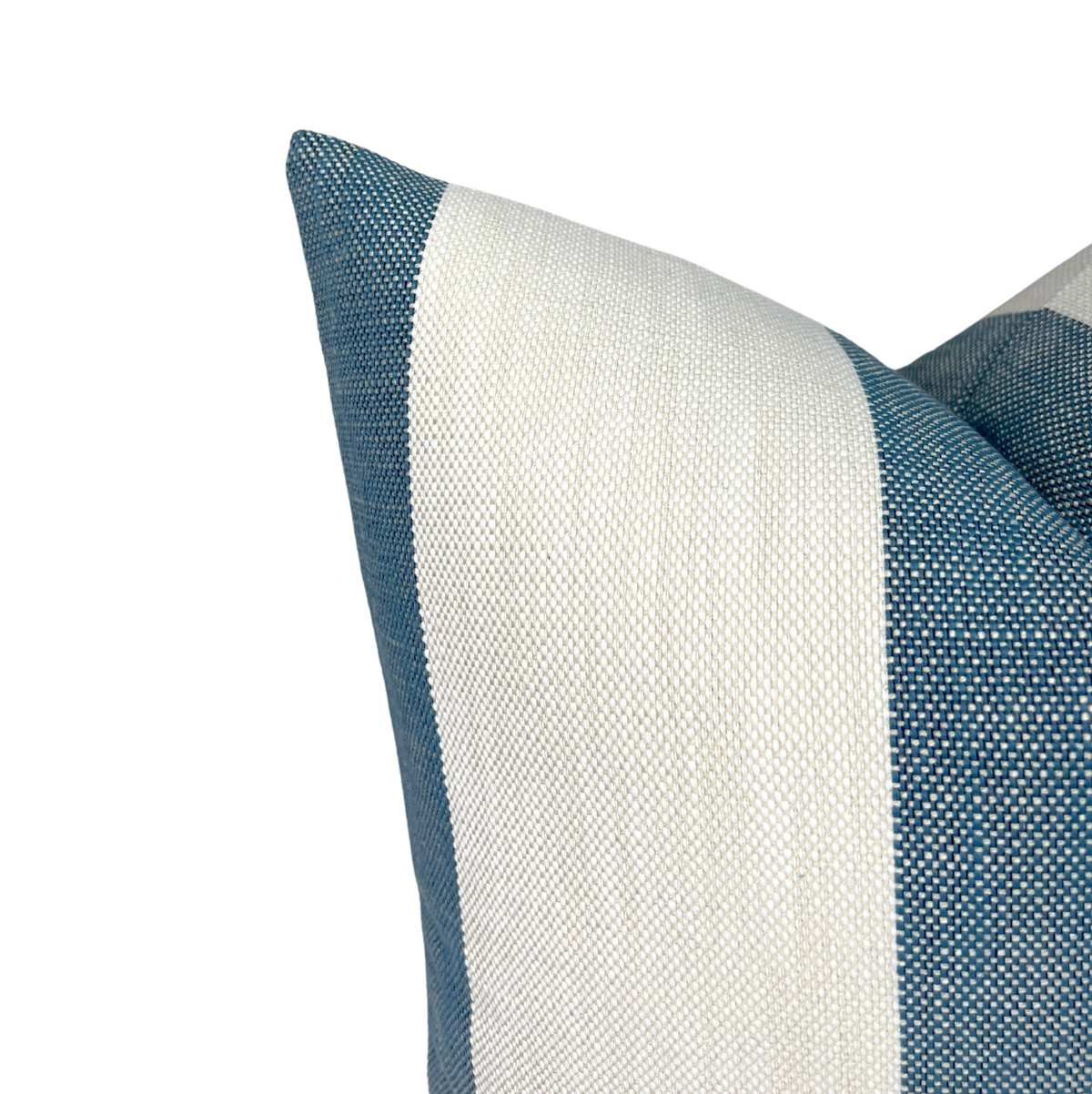 Close-up of a pillow cover with wide vertical stripes in white and lagoon blue textured fabric, showing detailed weave and sharp corner stitching.