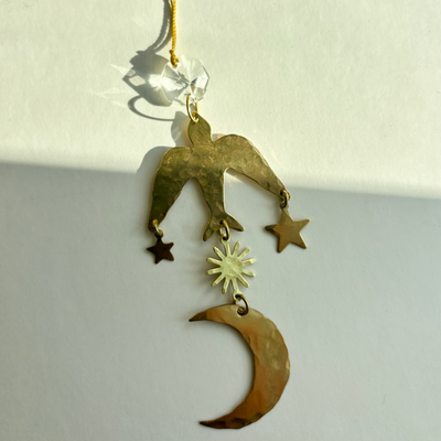 Flying Wonder Ornament by Vida + Luz, showing hand-hammered brass and vintage glass crystal hanging decor