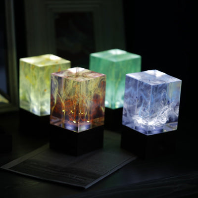 Handcrafted resin table lamp with ocean-inspired colors and warm white LED light