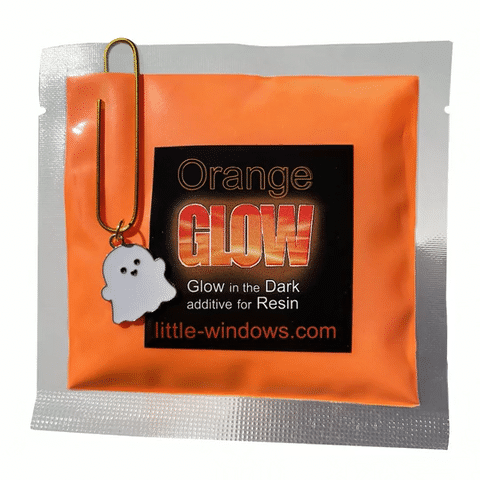 Orange glowing resin projects and glow-in-the-dark pigment pouch with a ghostie clip