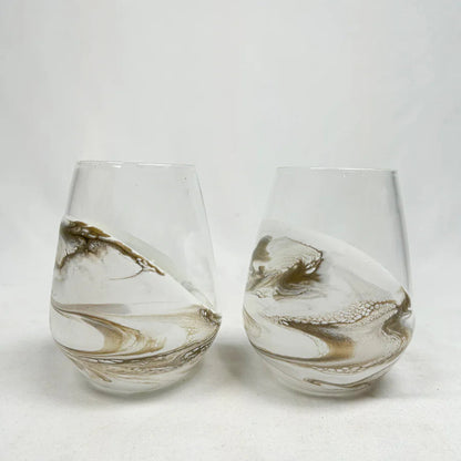 Two resin wine glasses with marbled design on a white background