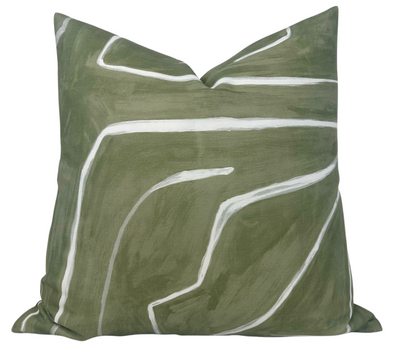 Graffito Pillow Cover in Fern Green by DEKOWE shown on sofa with abstract green linen pattern and ivory linen back