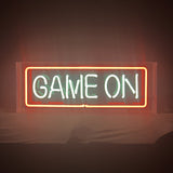 Game On Neon Sign illuminated with bright white light on acrylic backing hanging on a textured wall