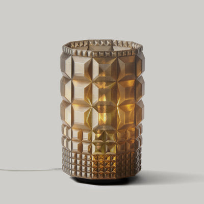 Gem Lamp by Wooj Design in smoky faceted glass on a wooden surface