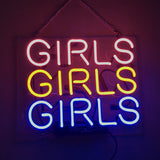 Rectangular neon sign with the word 'GIRLS' repeated in three rows, colored pink, yellow, and blue from top to bottom, hanging by a chain against a dark background.