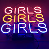 Neon sign with the word 'GIRLS' repeated three times in pink, yellow, and blue colors on a dark background