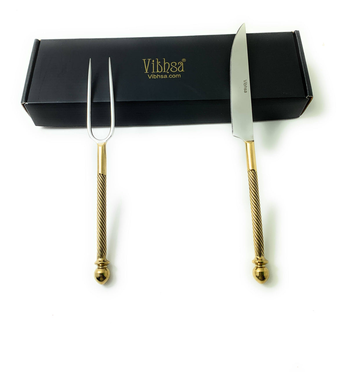 Set of two stainless steel carving tools with gold-toned textured handles, including a fork with two prongs and a knife with a straight-edged blade, displayed alongside a black box.
