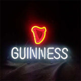 Neon sign with a glowing red harp symbol above white glowing text spelling GUINNESS against a black background.