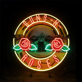 Circular neon sign with red 'Guns N Roses' letters, two red roses with green leaves inside a yellow ring, glowing against a dark background.