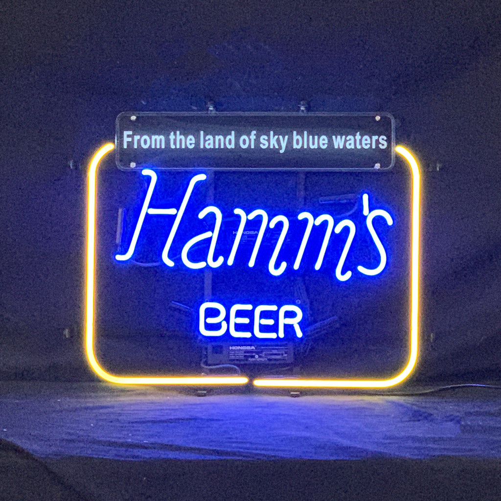 Hamm's Beer From the Land of Sky Blue Waters neon sign lit against a dark background