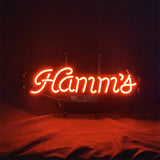 Red neon sign spelling "Hamm's" in cursive letters on a dark background with subtle reflections below.