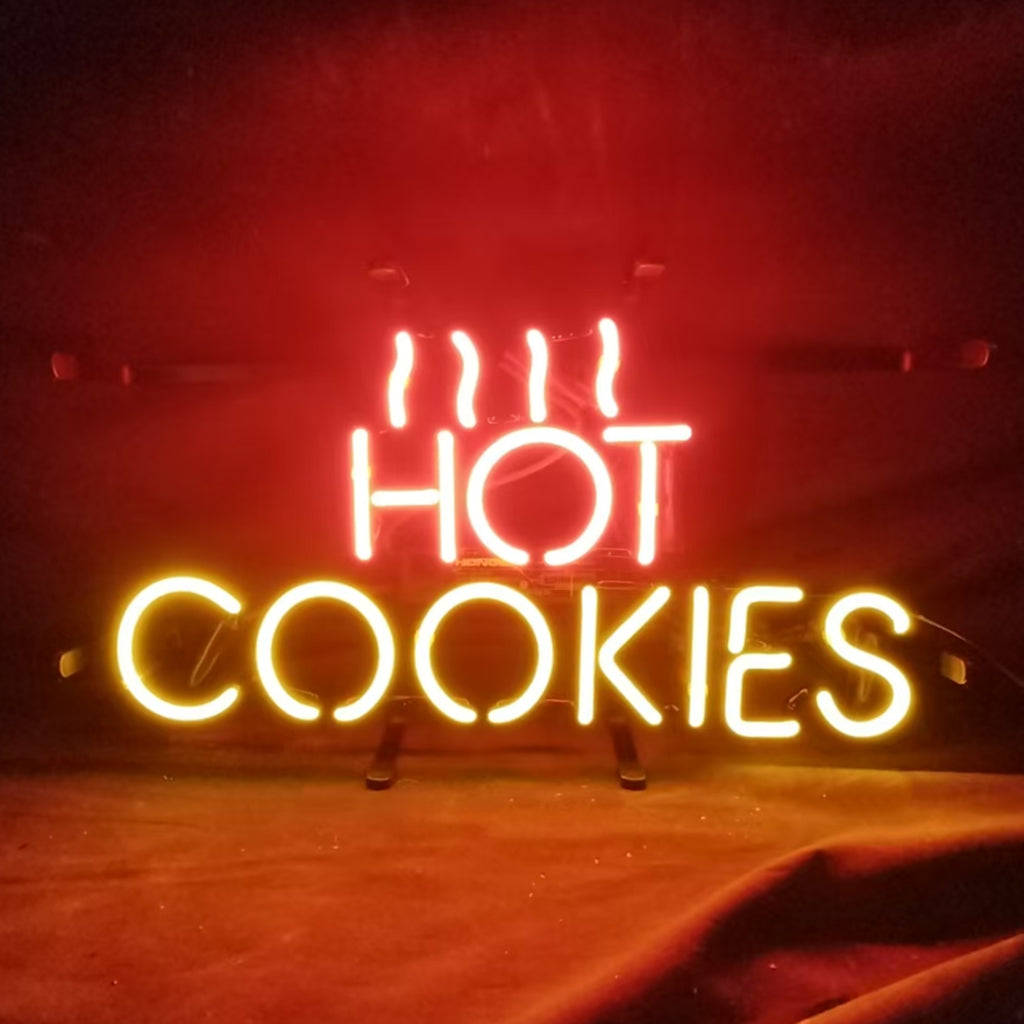 Hot Cookies Neon Sign glowing in warm pink tones on a metal grid backing