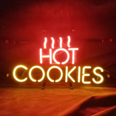 Hot Cookies Neon Sign glowing in warm pink tones on a metal grid backing